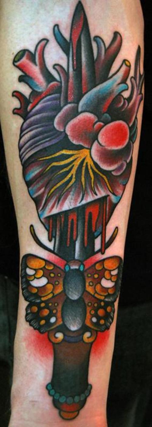Butterfly knife through heart tattoo.