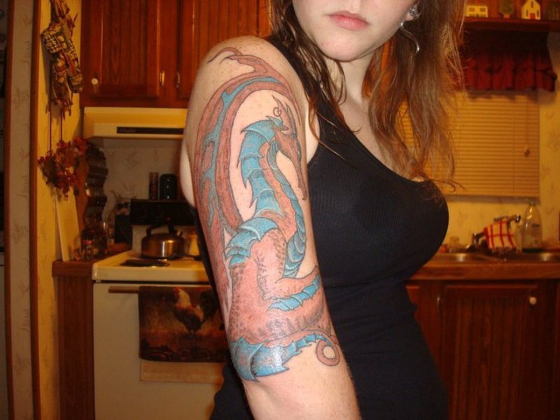 Dragon upper arm tattoo for women.