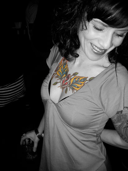 Beautiful flowery chest tattoo on woman.