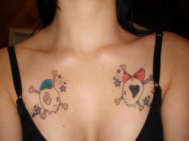 breast tattoos for women. Cartoon skull and crossbones chest tattoo.