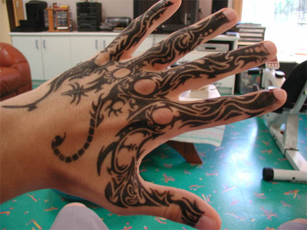 Tribal Side Tattoos. Name tattoo on side of hand.