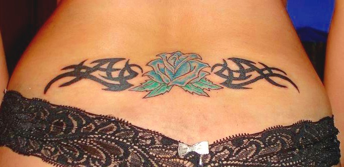 tattoo ideas for women lower back. Tribal and rose ideas.