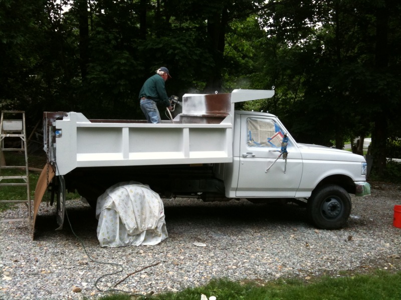 Keenan Construction & Excavation Painting the dumptruck