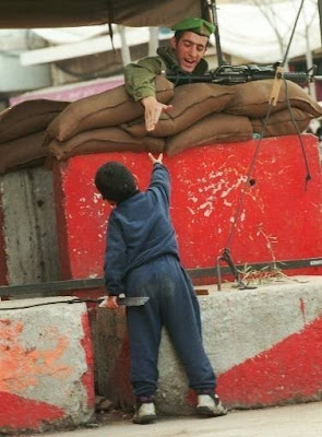 Israeli%20soldier%20giving%20a%20hand%20to%20a%20Palestinian%20boy.jpg