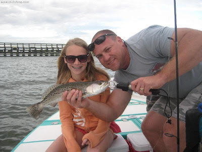 man and girl with speckled sea trout