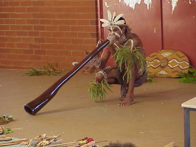 playing a didgeridoo.