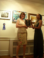 Helene Miller accepts the Inner Essence award from Tyme Gallery's owner Edna Davis