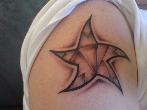 there he picked up at a port of call a red, five-pointed star tattoo.