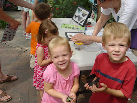 Tyler and Abby holding butterflies