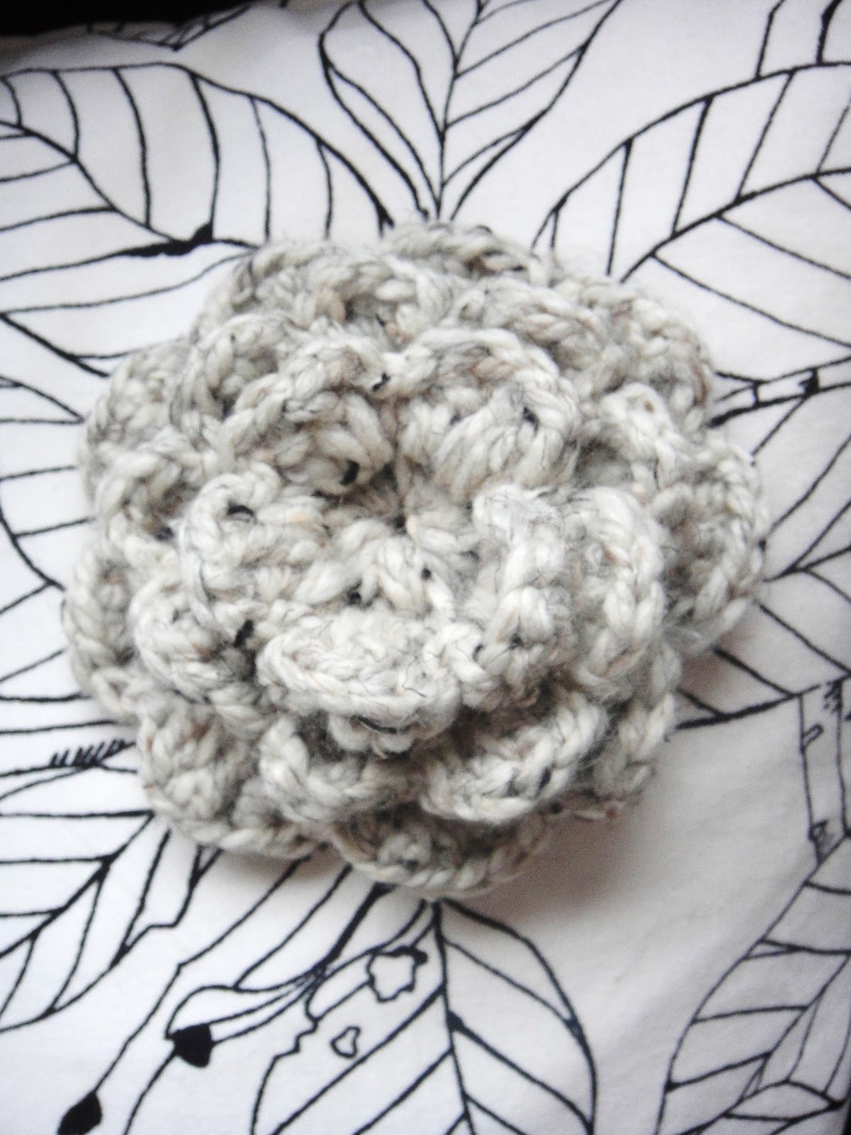 Crocheted ear warmer with flower