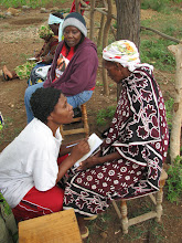 A Kikwe woman casting her vote who is unable to write