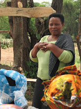 A trainer from Village Bank speaking with Kikwe women