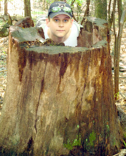 Joshua DeLung in a stump on a Blue Ridge Parkway trail