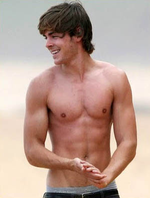 Zac Efron shirtless on a beach