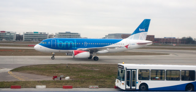 a blue and white airplane on a runway