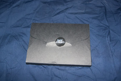 a black envelope with a circle on it