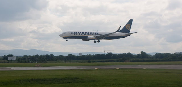 a plane flying over a runway