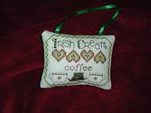 Green ornament stitched on aida