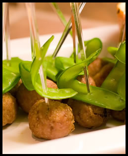 asian meatballs with a snow pea pick