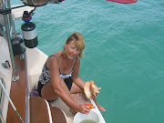 Cleaning conchs on the stern of Little Wing