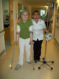 Sarah walks back to her bed from the playroom with nurse Krissy