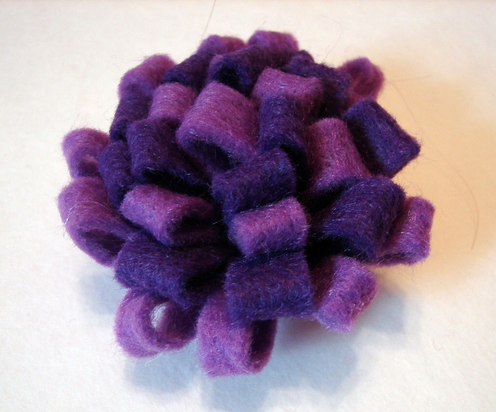 A girl and a glue gun felt flowers.