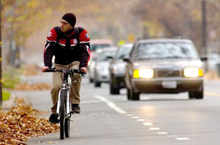 Image of bicyclist being overtaken by vehicles