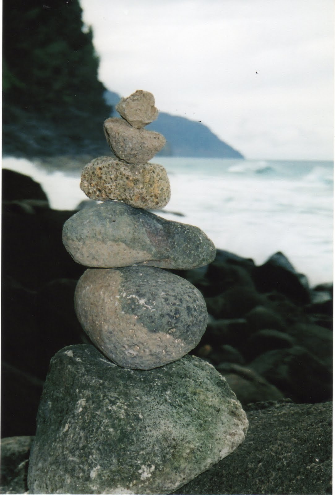 Stacked rocks on the beach by Rick Dones