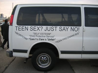 Other side of the white van. Some quotes include 'SELF ESTEEM' and 'ABORTIONS'