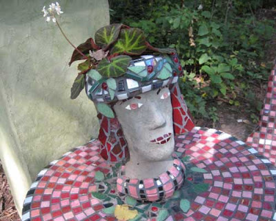 Head and neck as a heavy vase, begonia growing out of the head