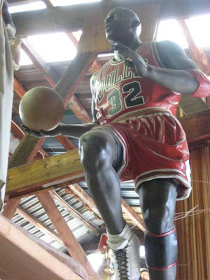 Michael Jordan in Bulls uniform, mid-stride, shot from below
