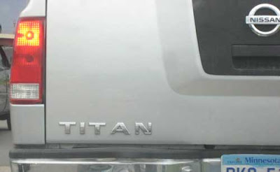 Backend of a Nissa Titan truck. The letters TITAN are badly space so they appear to read TIT AN