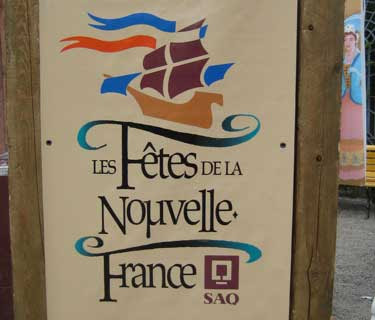 Stylized tall ship and the words La Fete de la Nouvelle France