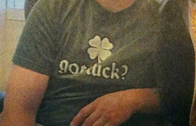 Closeup of boy's t-shirt, which looks like it says Got dick? but probably says Got luck?