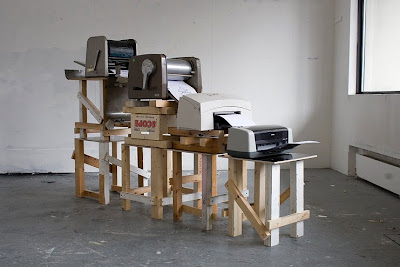 Four printers sitting on different-height tables