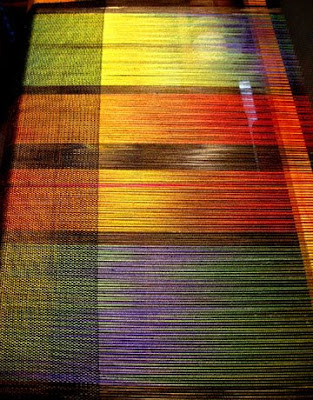 Ikat painted silk being woven Ikat painted silk being woven