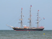 A tall ship leaves port