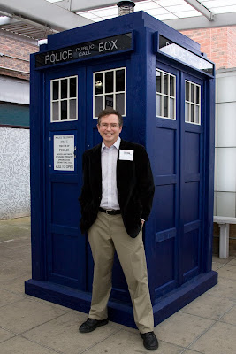 Jim Fruchterman in front of a blue police box/the Tardis from Dr.  Who