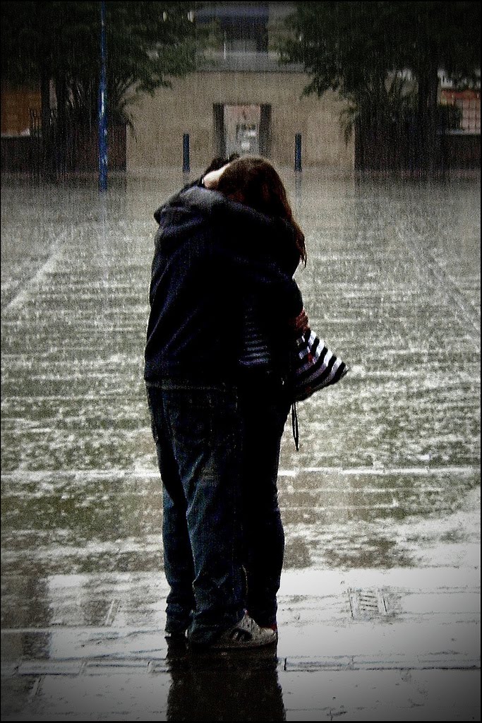 young couple kissing in the rain. bookmarks young couple