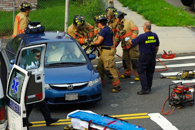 Holyoke Fire Rescue use the jaws of life to open the drivers door of this blue car in Holyoke, MA