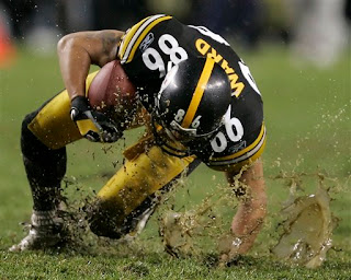 Hines Ward sloshes through a puddle
