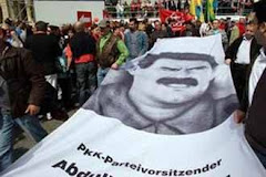 Kurds carry a banner with their leader Ocalan