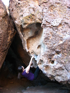 Jenn emerging from the cave on Sunburst Seahorse at the Happy Boulders