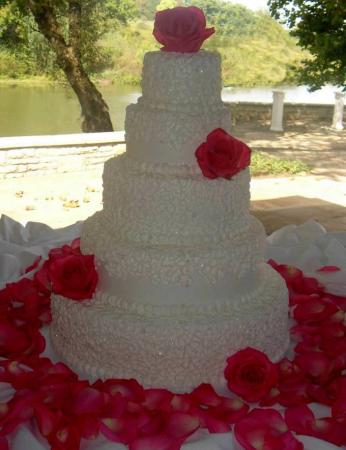 A gorgeous buttercream wedding cake with white buttercream icing and 