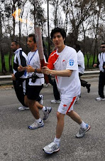 Leehom is holding the Olympic fire