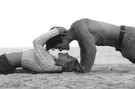 Romantic young couple kissing on the beach