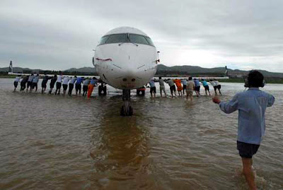 Airplane Airplane being push out of flooded areas