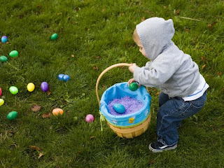 la pascua little kid or children taking the colored eggs into basket after hunting  in the garden or lawn sexy image