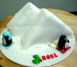Cute penguins on Christmas cake made as two snow hills Hoel hot picture