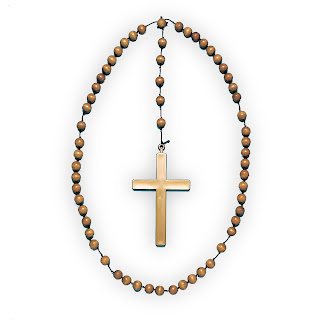 Yellow color cross in center of Yellow beads of the rosary in circular shape picture